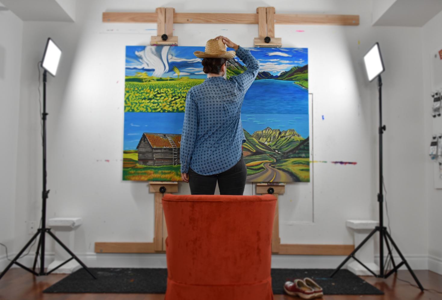 Canadian Artist Brandy Saturley in her studio with landscape paintings