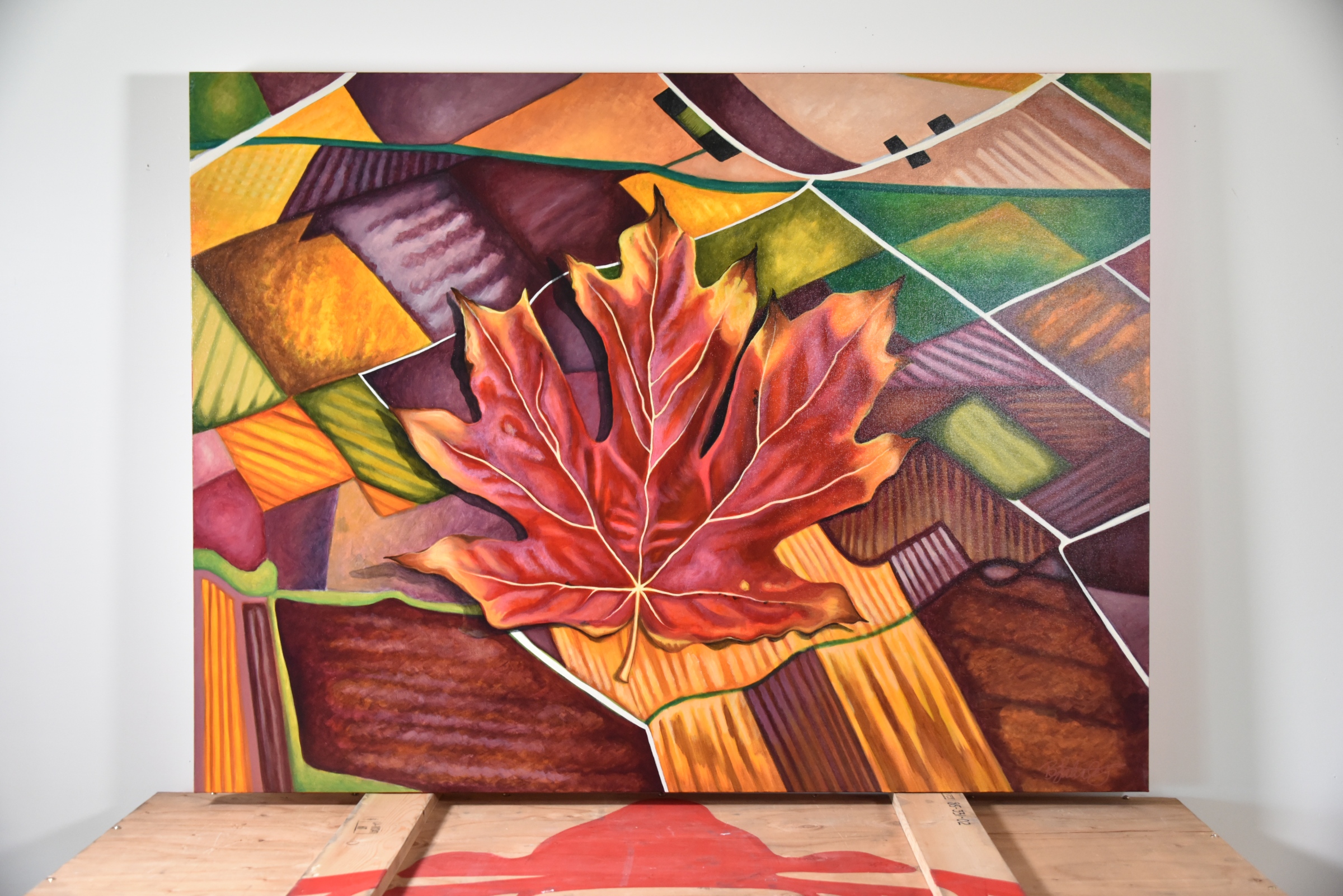 painting of maple leaf on prairies