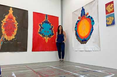 Brandy Saturley with her paintings at RCA Sackler Studios